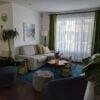 a living room filled with furniture and a large window